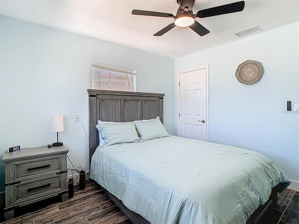 4984 Cedarbrook Lane Hernando Beach, FL 34607 - Photo 40 of 61 a bedroom with a bed and a chandelier