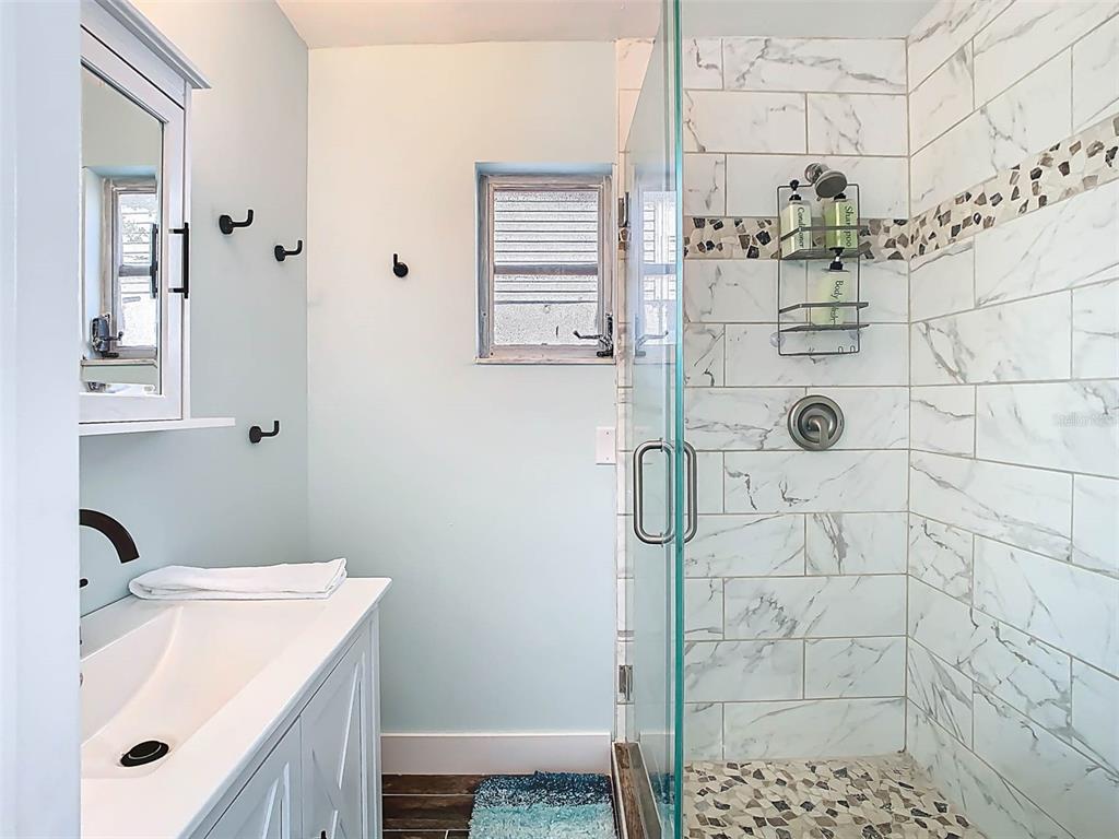 4984 Cedarbrook Lane Hernando Beach, FL 34607 - Photo 42 of 61 a bathroom with a sink toilet and shower