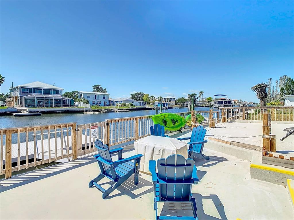 4984 Cedarbrook Lane Hernando Beach, FL 34607 - Photo 49 of 61 a view of a swimming pool with outdoor seating and plants