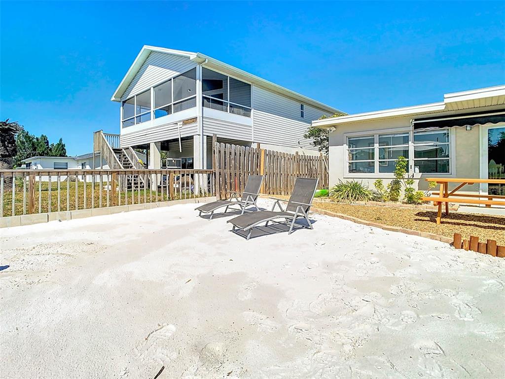 4984 Cedarbrook Lane Hernando Beach, FL 34607 - Photo 55 of 65 a front view of a building with a patio