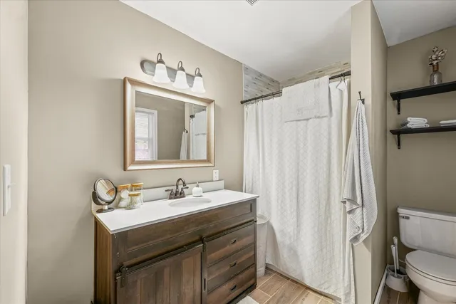 a bathroom with a sink a toilet and a mirror