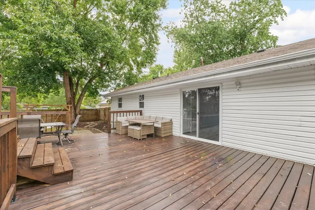 a view of a deck with chairs and wooden floor