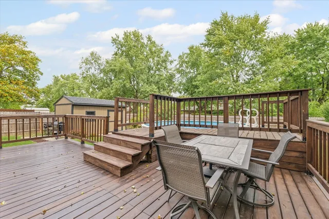 a view of a patio with a table and chairs