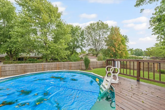 a view of a roof deck with wooden floor and fence