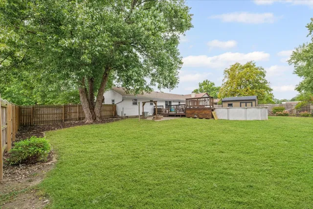 a view of a house with a backyard