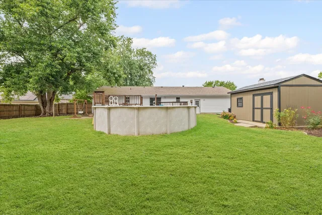 a view of a house with a yard and a patio