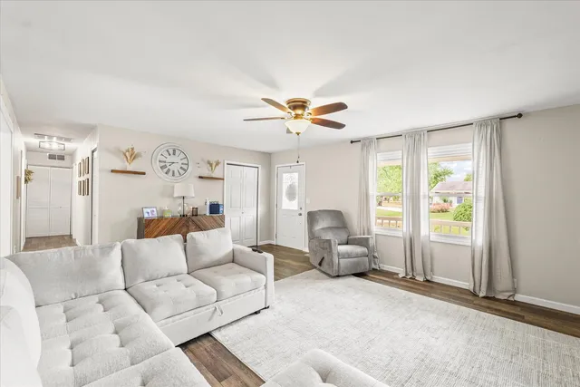 a living room with furniture and a large window with garden view