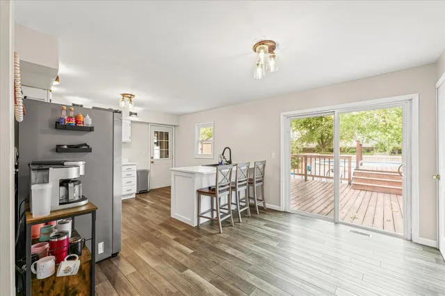 a view of a dining room with furniture a chandelier and wooden floor