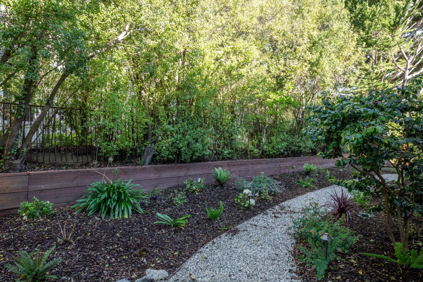 11 Fairway Place Half Moon Bay, CA 94019 - Photo 12 of 42 a view of a garden with plants and large trees