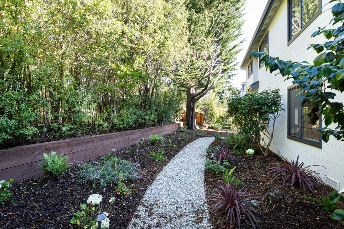11 Fairway Place Half Moon Bay, CA 94019 - Photo 13 of 42 a view of a garden with plants and large trees