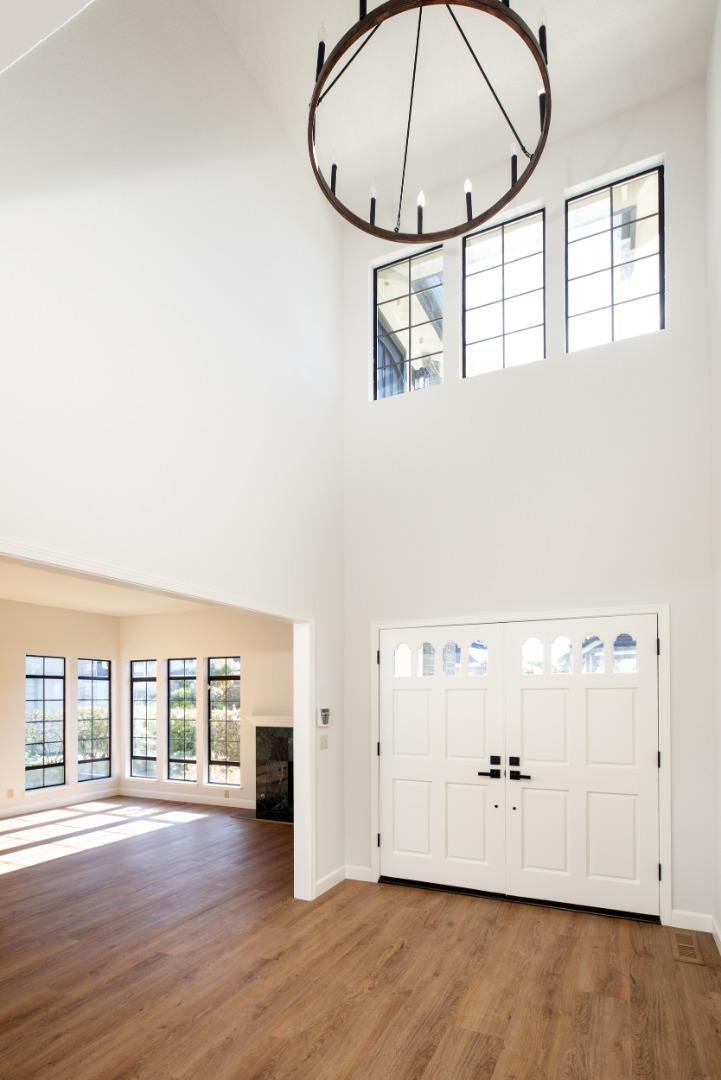 11 Fairway Place Half Moon Bay, CA 94019 - Photo 14 of 42 an empty room with wooden floor and windows