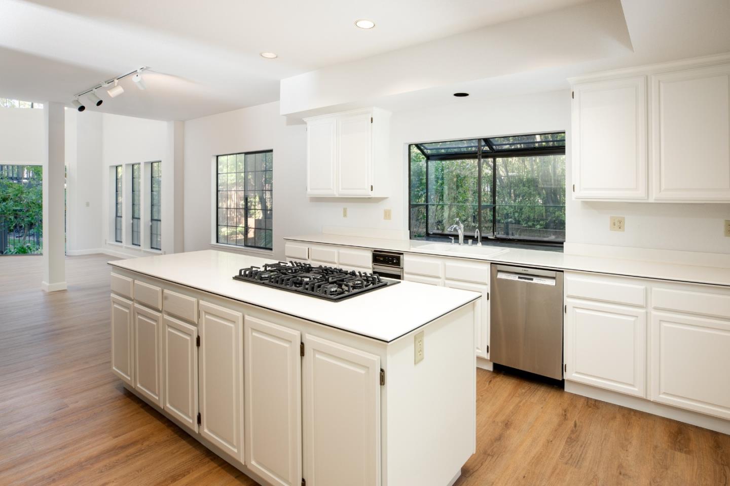 11 Fairway Place Half Moon Bay, CA 94019 - Photo 22 of 42 a kitchen with granite countertop white cabinets and white appliances