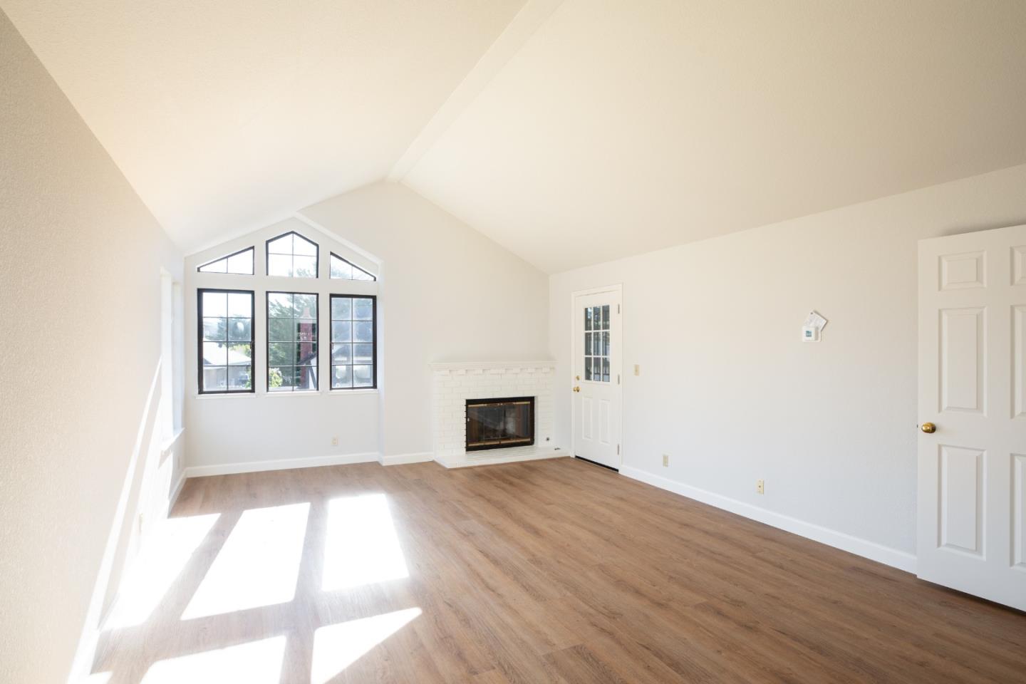 11 Fairway Place Half Moon Bay, CA 94019 - Photo 28 of 42 an empty room with windows and fireplace