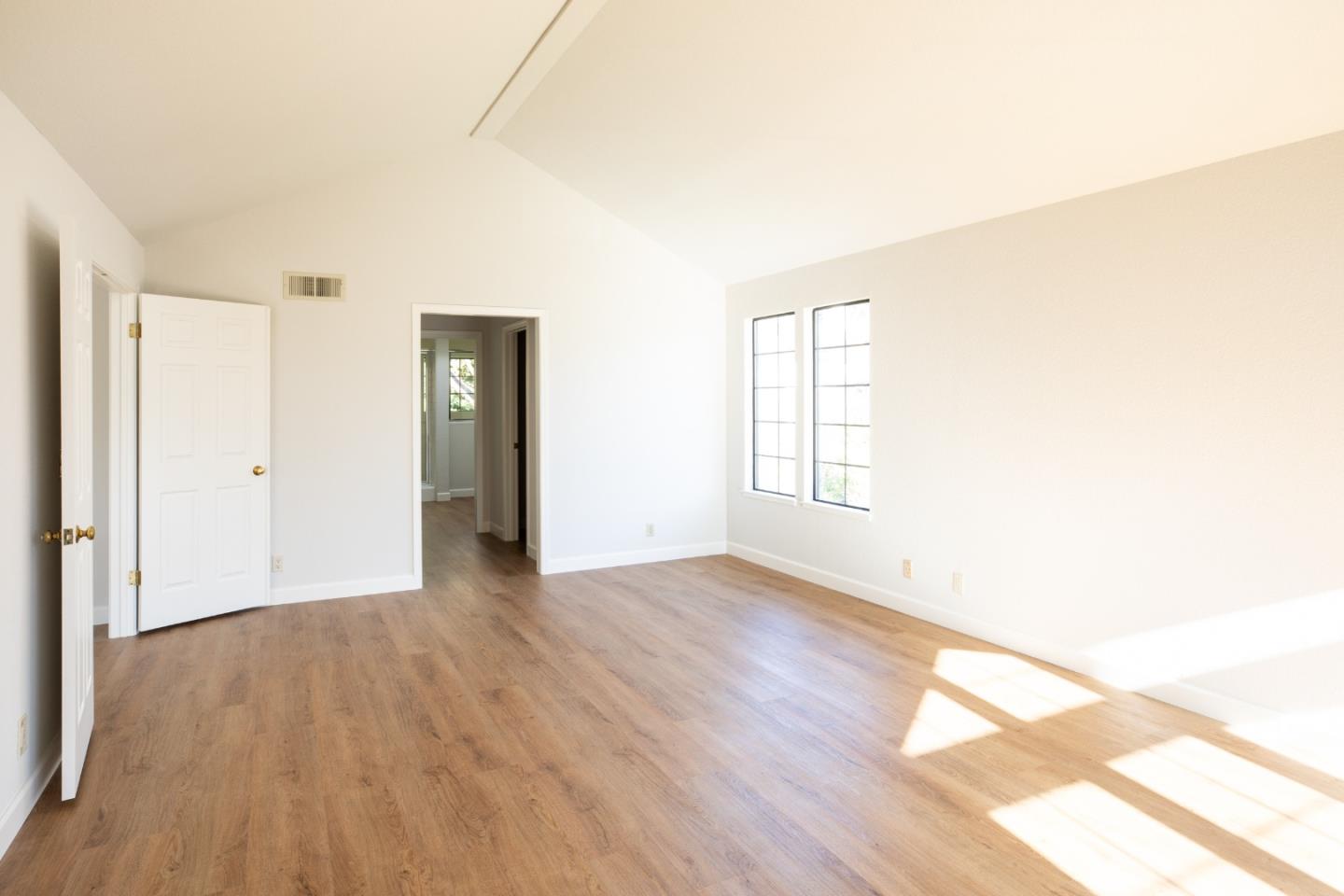 11 Fairway Place Half Moon Bay, CA 94019 - Photo 30 of 42 an empty room with wooden floor and windows
