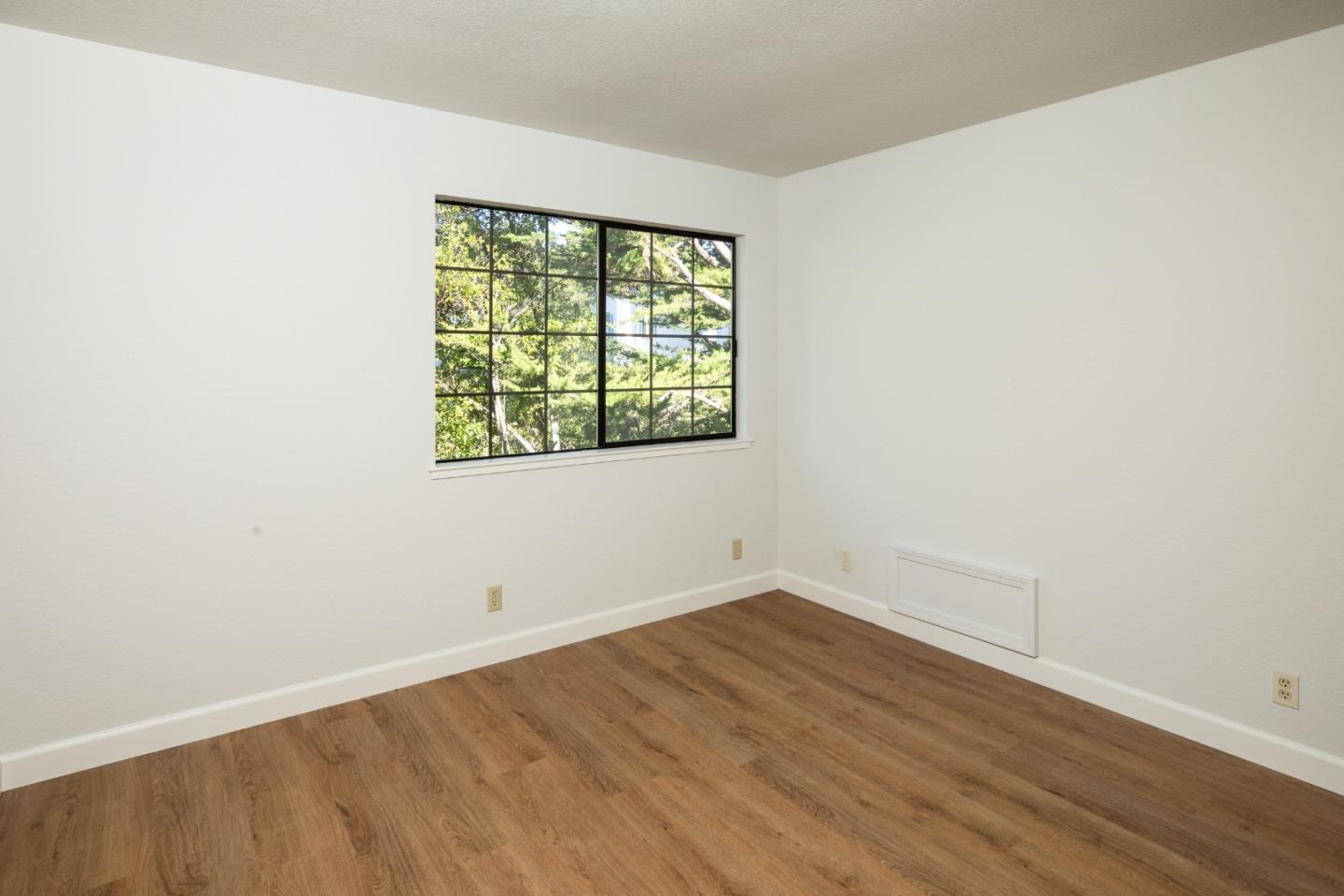 11 Fairway Place Half Moon Bay, CA 94019 - Photo 36 of 42 an empty room with wooden floor and windows