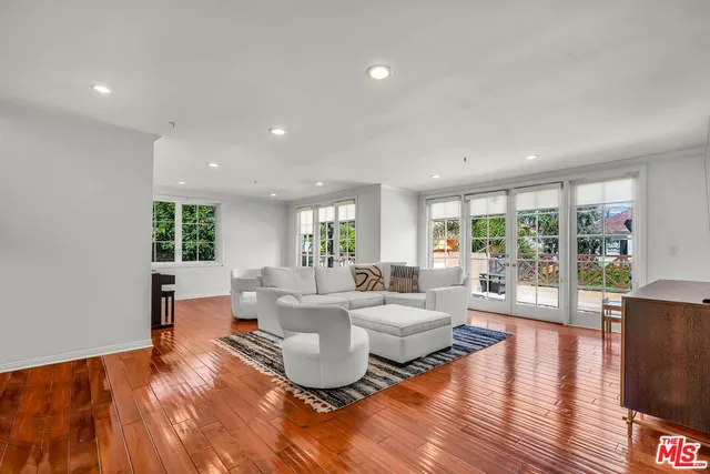 a living room with fireplace furniture and a wooden floor