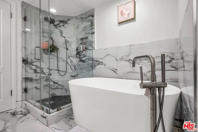 a bathroom with a sink a mirror and shower