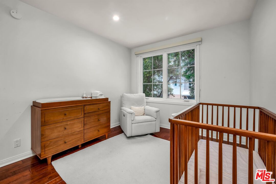 10555 Ashton Avenue, Unit 201 Los Angeles, CA 90024 - Photo 27 of 33 a bedroom with furniture and a window