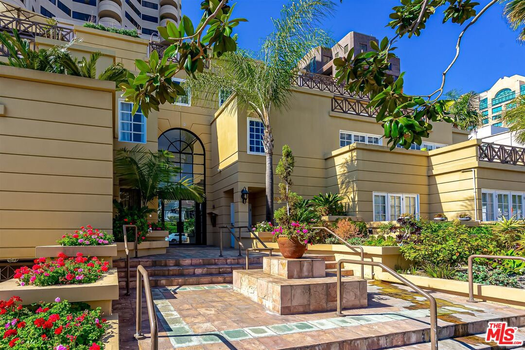 10555 Ashton Avenue, Unit 201 Los Angeles, CA 90024 - Photo 4 of 33 a front view of multi story residential apartment building with yard and seating