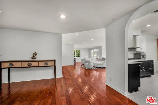a view of living room with furniture and wooden floor