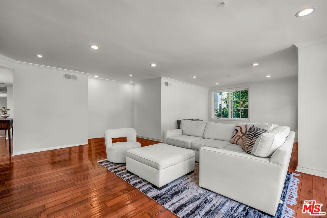 10555 Ashton Avenue, Unit 201 Los Angeles, CA 90024 - Photo 7 of 33 a living room with furniture and a wooden floor