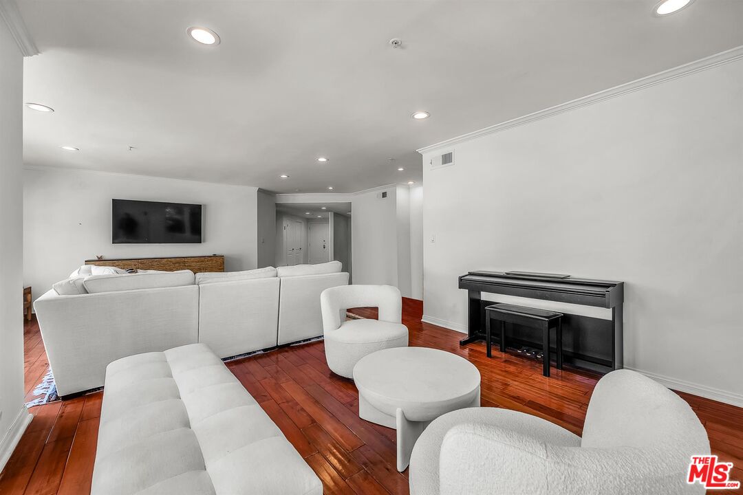 10555 Ashton Avenue, Unit 201 Los Angeles, CA 90024 - Photo 9 of 33 a living room with furniture and a flat screen tv