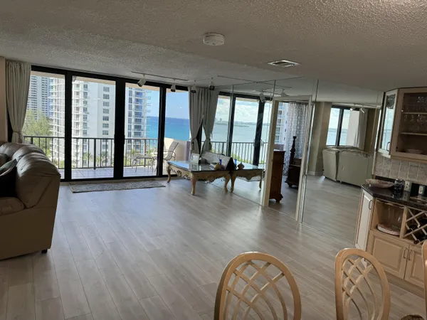 a living room with furniture and large windows