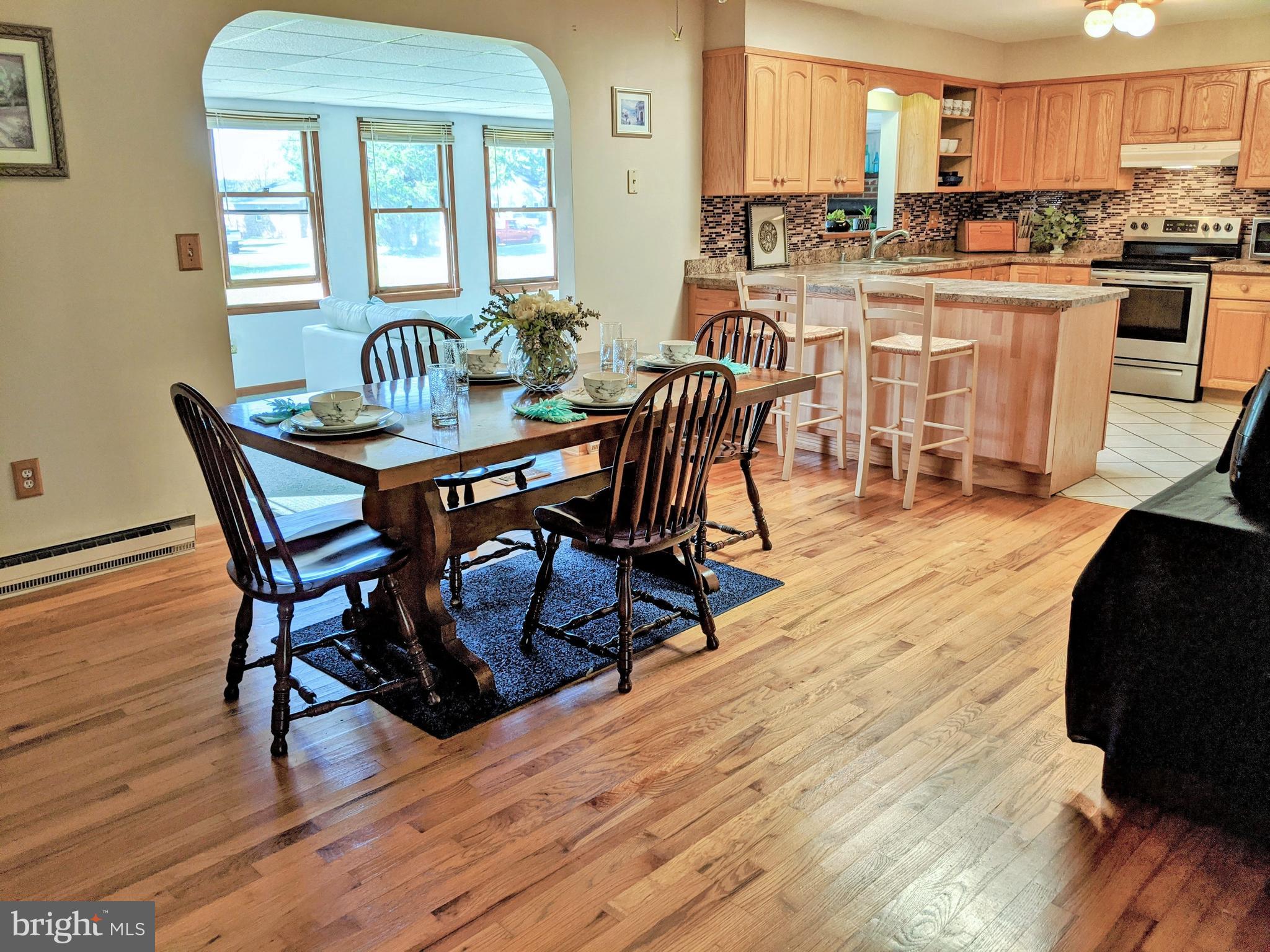 1342 Calvert Road Chester, MD 21619 - Photo 11 of 29 a view of a dining room with furniture and wooden floor