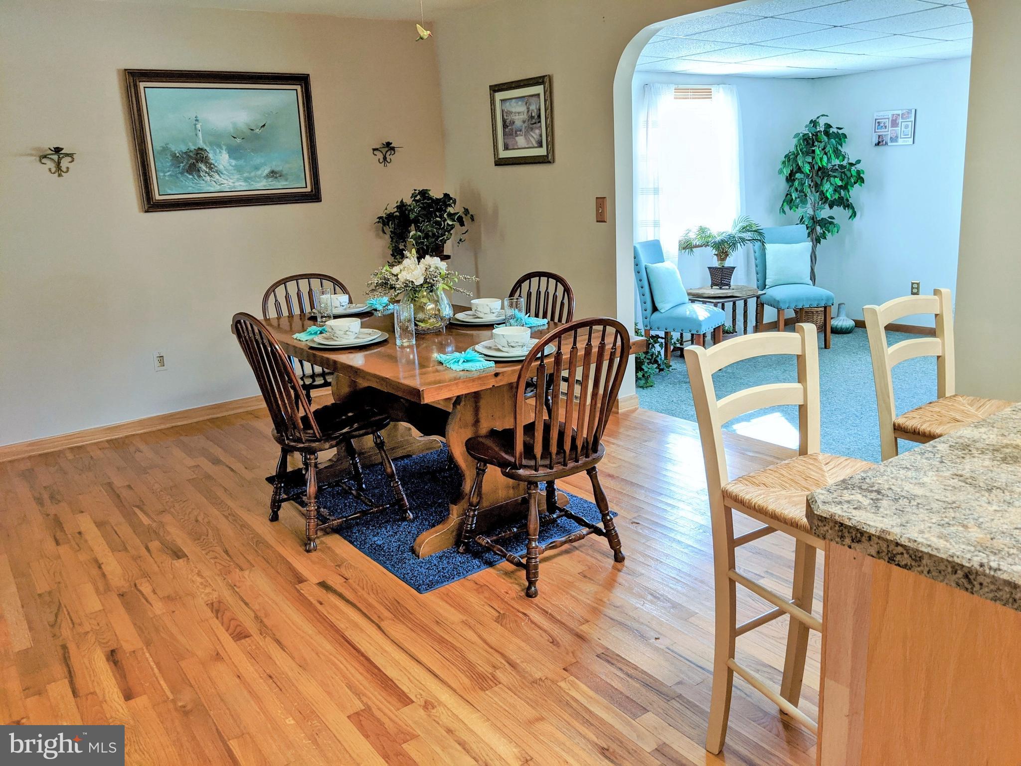 1342 Calvert Road Chester, MD 21619 - Photo 12 of 29 a view of a dining room with furniture and wooden floor