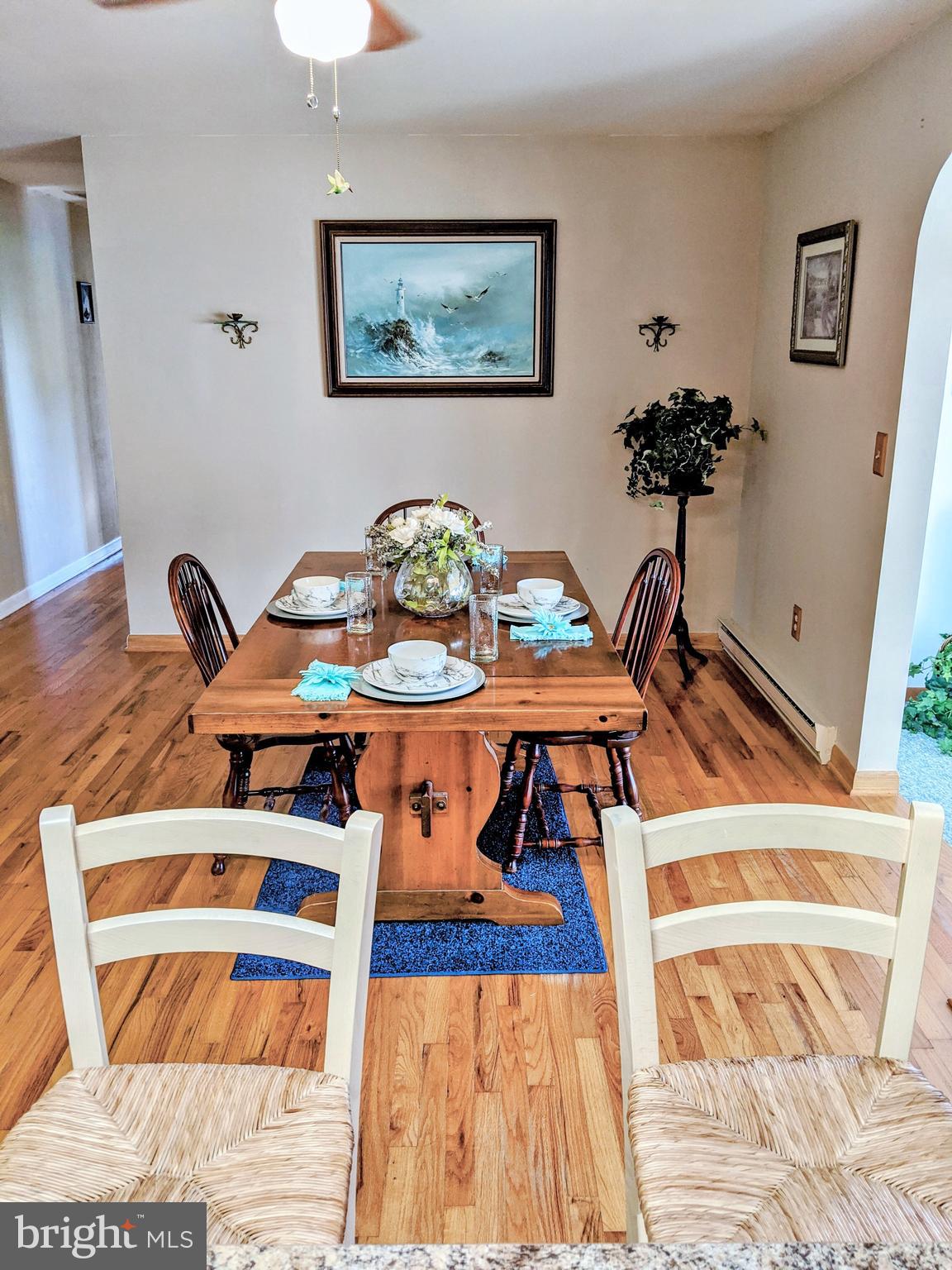 1342 Calvert Road Chester, MD 21619 - Photo 13 of 29 a view of a dining room with furniture and wooden floor