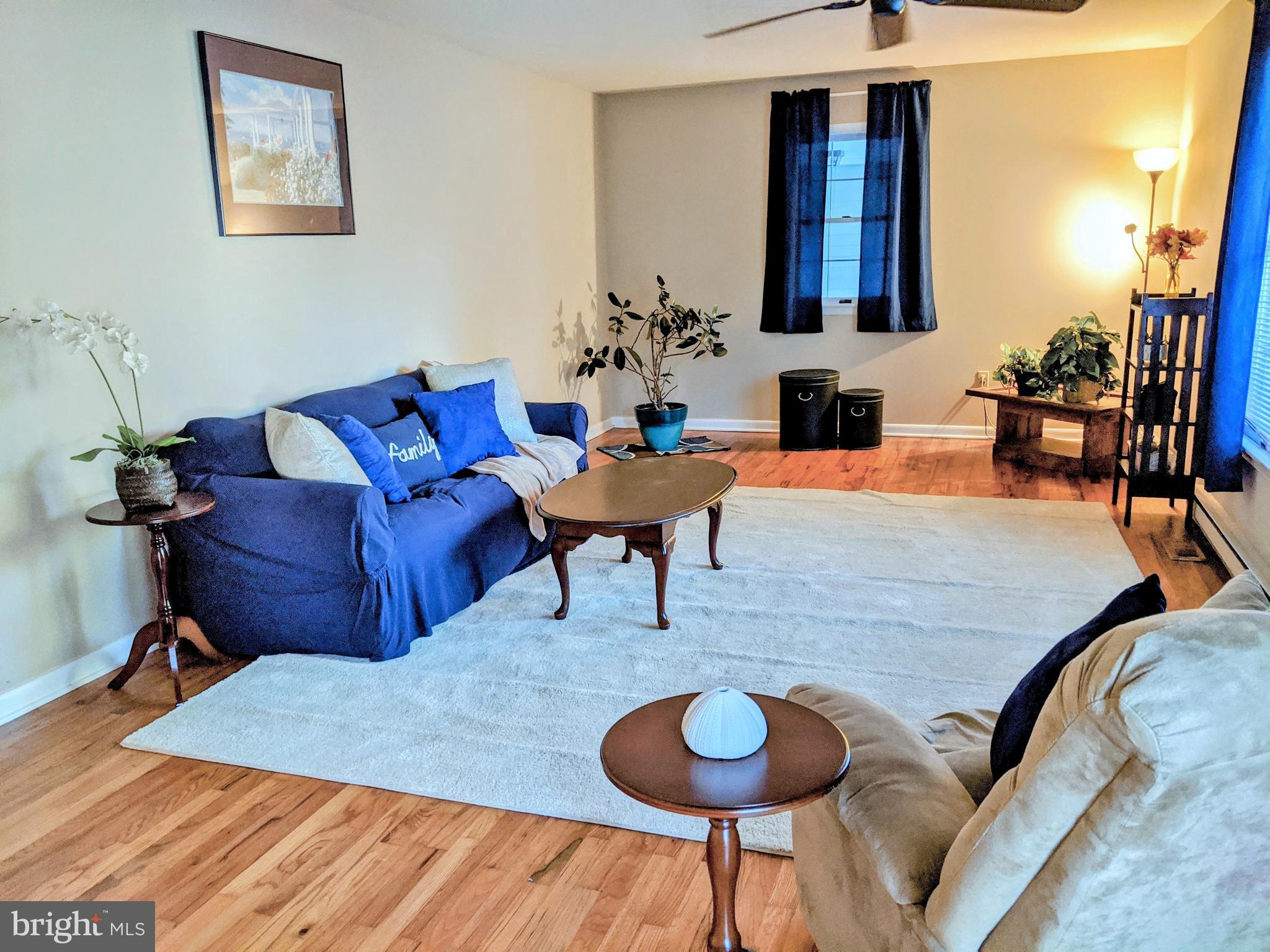 1342 Calvert Road Chester, MD 21619 - Photo 19 of 29 a living room with furniture and a chandelier