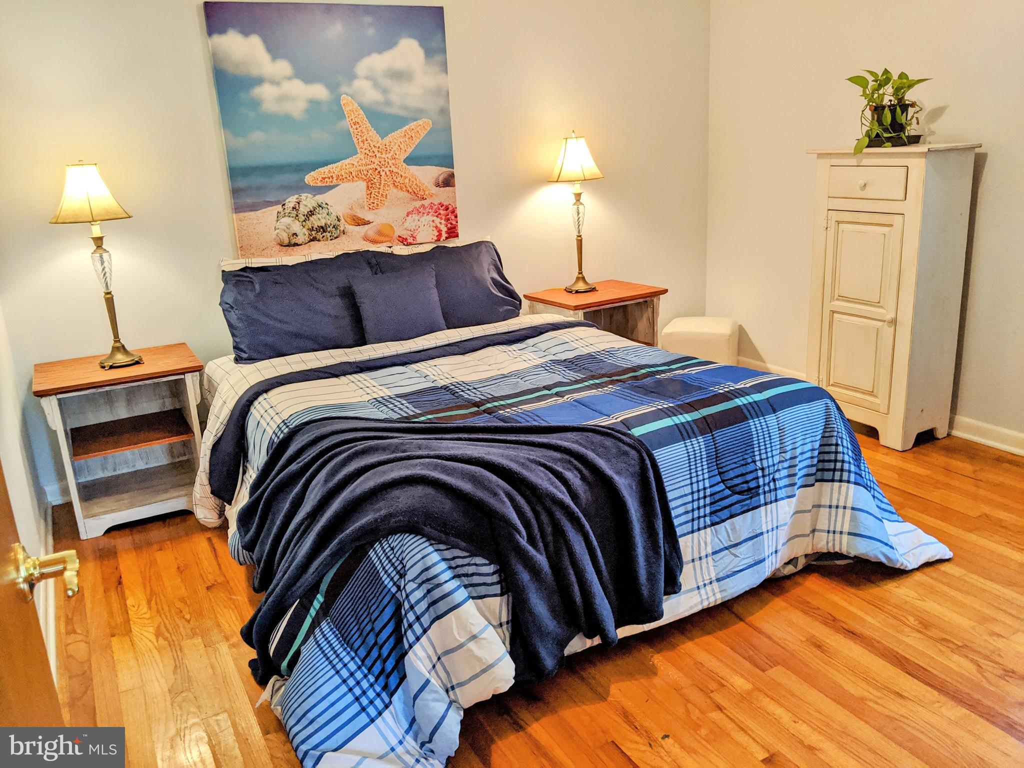 1342 Calvert Road Chester, MD 21619 - Photo 21 of 29 a bedroom with a bed and lamp