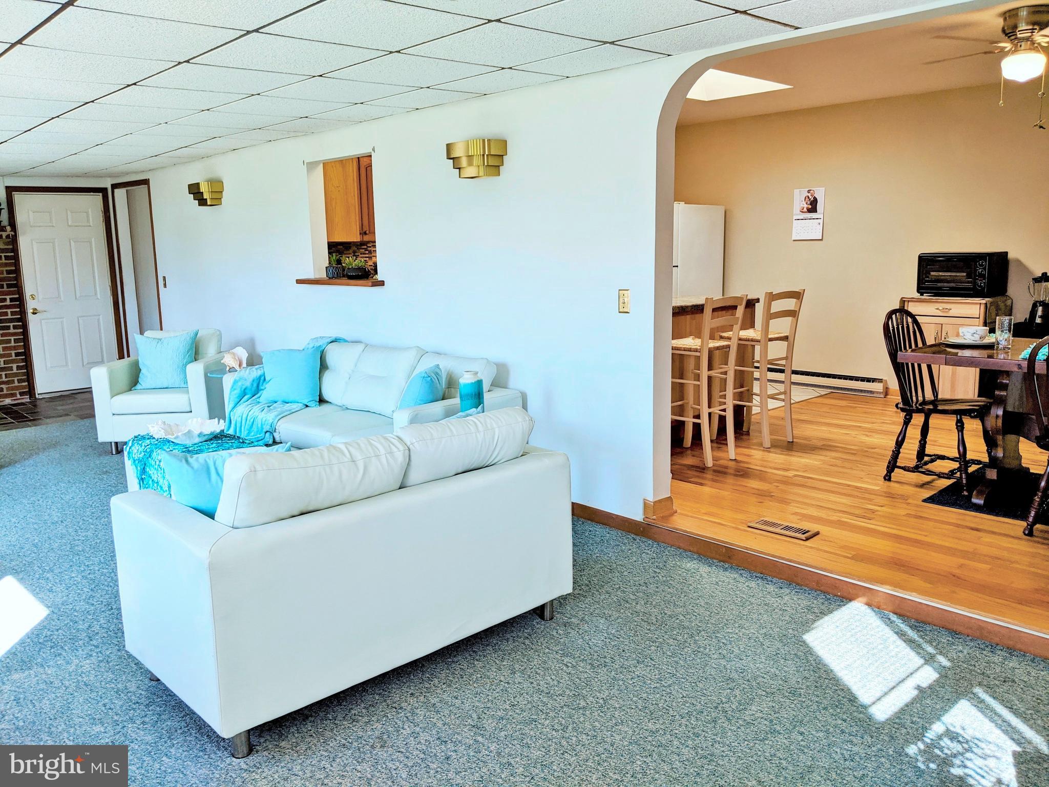 1342 Calvert Road Chester, MD 21619 - Photo 3 of 29 a living room with furniture and a dining table with wooden floor