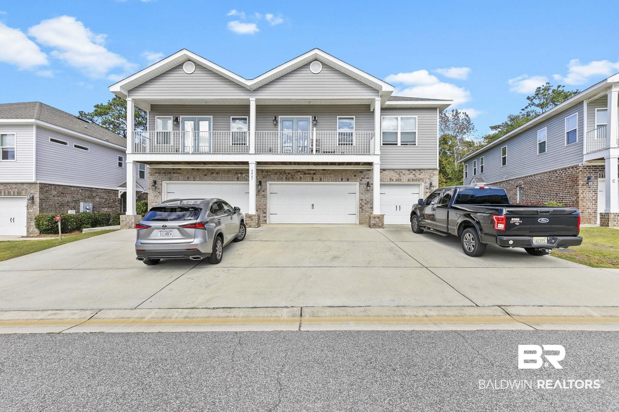 6867 Spaniel Drive, Unit B Daphne, AL 36527 - Photo 1 of 36 View of front of home with a balcony and a garage