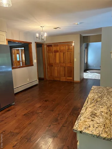 a view of an empty room and wooden floor