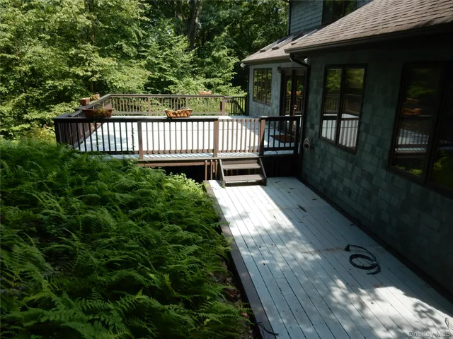 a view of backyard with deck and garden