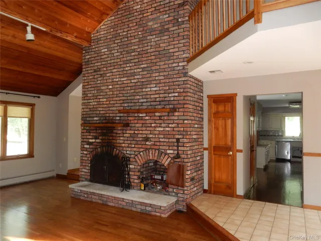 a view of empty room with a fireplace