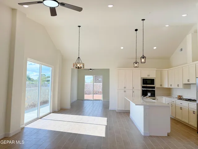 a view of a kitchen with microwave and cabinets