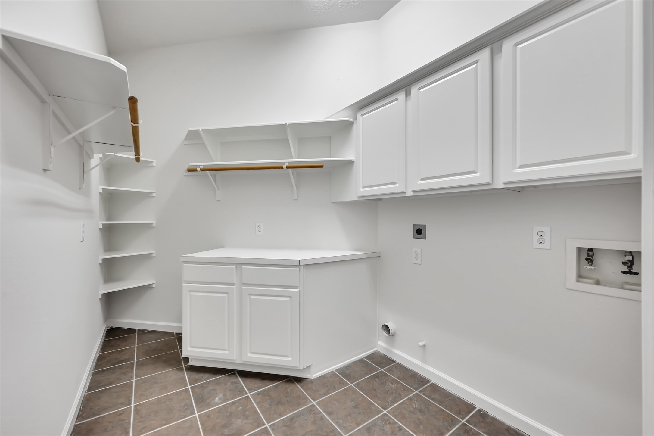 47 Presidio Road Montgomery, TX 77356 - Photo 13 of 35 a view of cabinets and utility room with racks on the wall