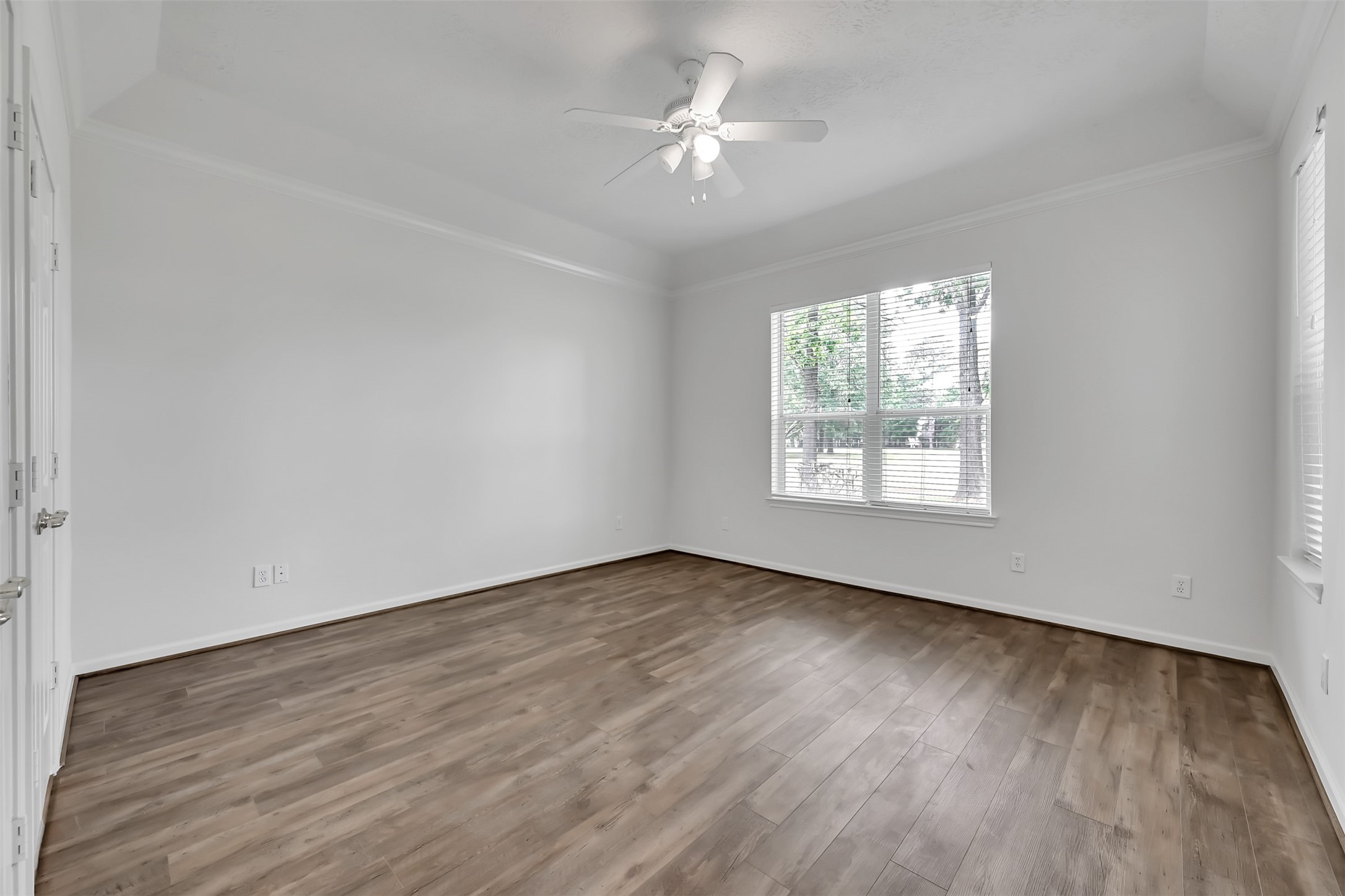 47 Presidio Road Montgomery, TX 77356 - Photo 14 of 35 an empty room with wooden floor chandelier fan and windows