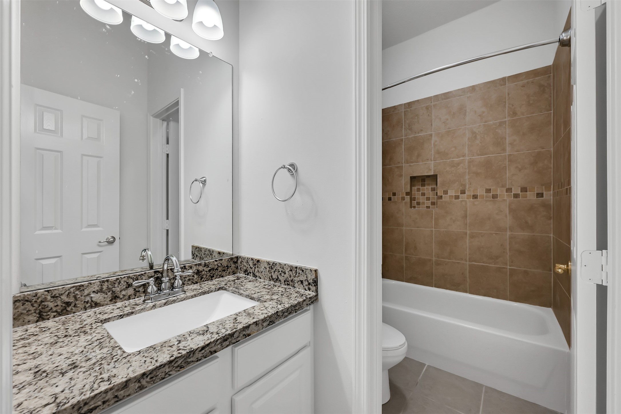 47 Presidio Road Montgomery, TX 77356 - Photo 22 of 35 a bathroom with a granite countertop sink a toilet and bathtub
