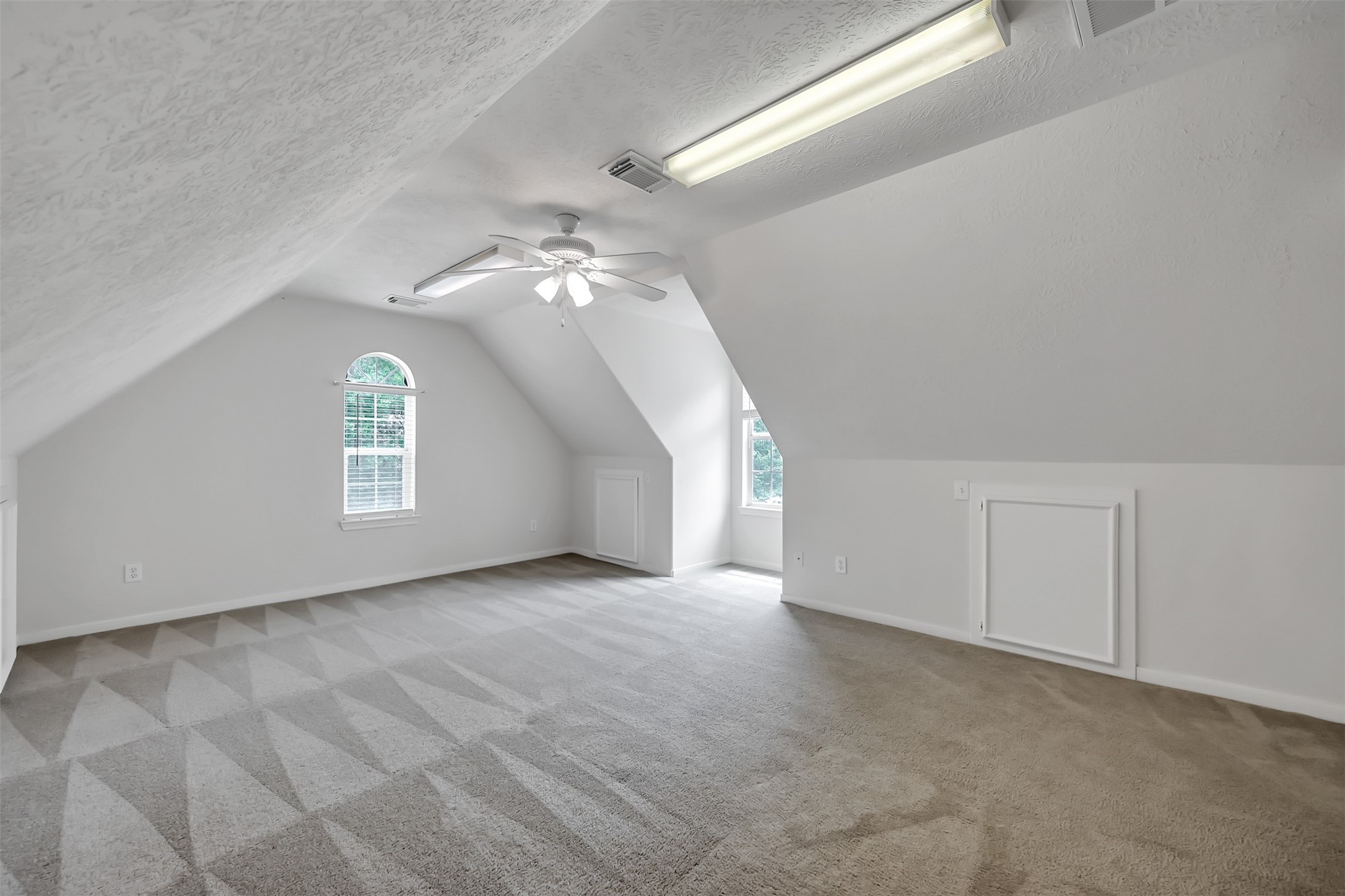 47 Presidio Road Montgomery, TX 77356 - Photo 29 of 35 an empty room with windows and chandelier fan