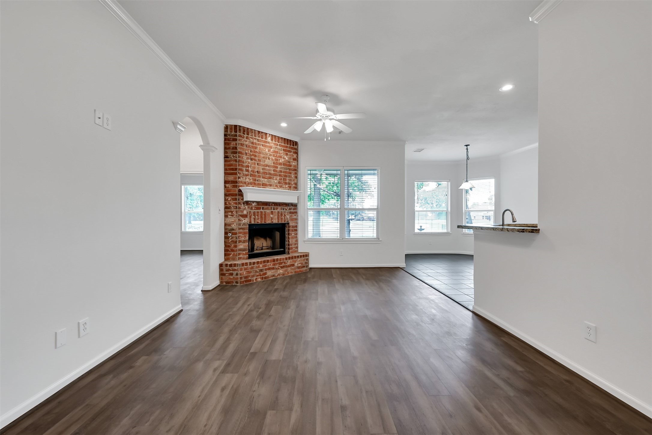 47 Presidio Road Montgomery, TX 77356 - Photo 5 of 35 an empty room with wooden floor a fireplace and windows