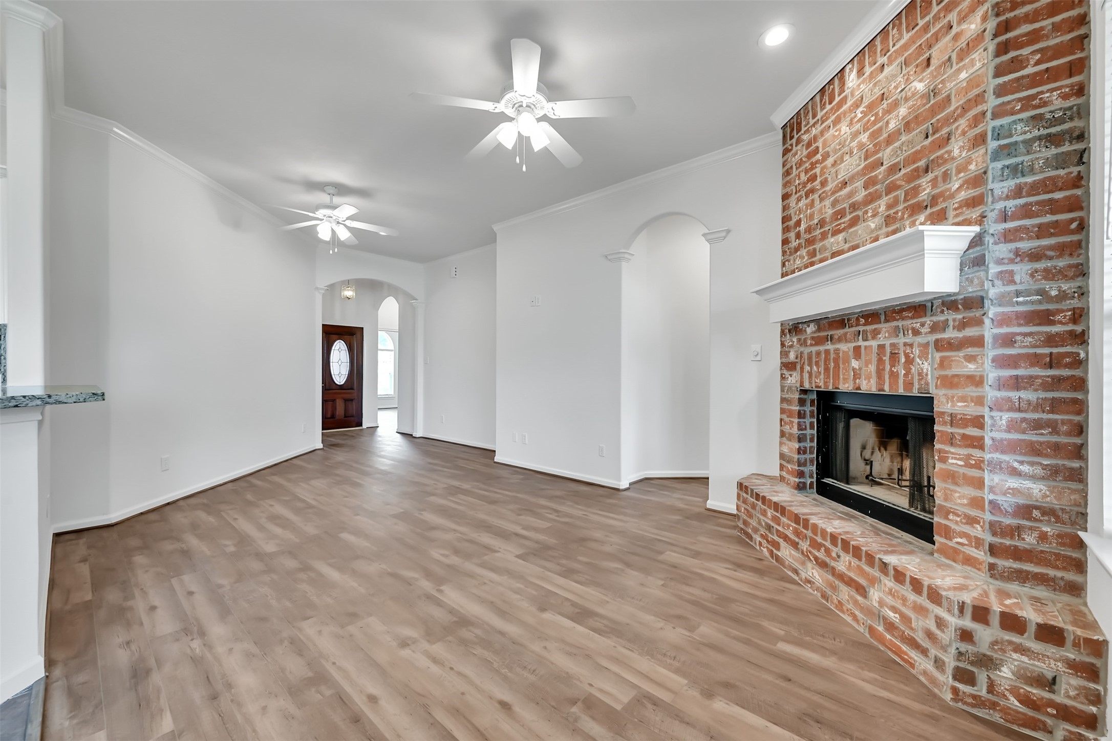 47 Presidio Road Montgomery, TX 77356 - Photo 6 of 35 a view of a livingroom with a fireplace a chandelier and wooden floor