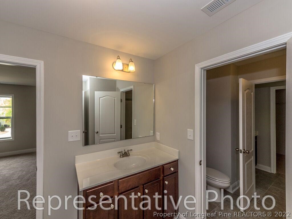 4141 McBryde Road Linden, NC 28356 - Photo 21 of 28 a bathroom with a sink and a mirror
