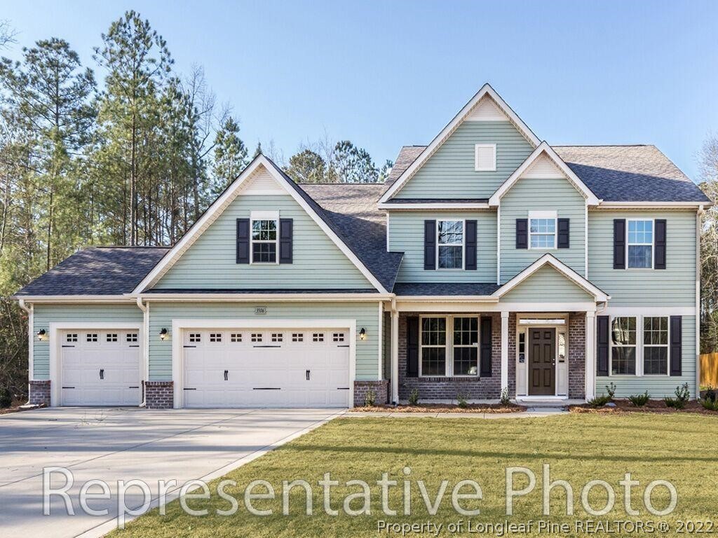 4141 McBryde Road Linden, NC 28356 - Photo 3 of 28 a view of a house with a big yard and potted plants