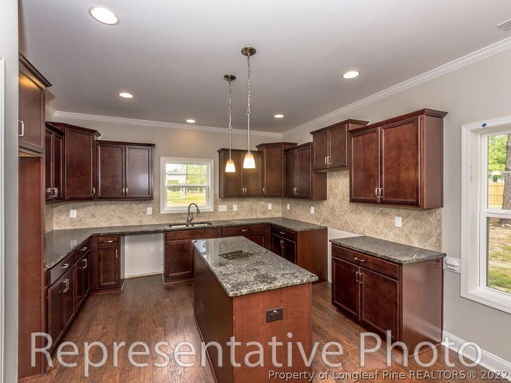 4141 McBryde Road Linden, NC 28356 - Photo 9 of 28 a large kitchen with granite countertop a stove and a sink