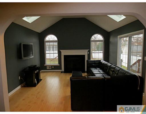 414 New Market Road Dunellen, NJ 08812 - Photo 11 of 25 a living room with furniture and a fireplace