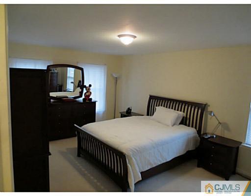 414 New Market Road Dunellen, NJ 08812 - Photo 12 of 25 a bedroom with a bed and dresser
