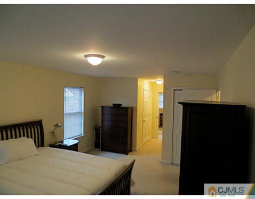 414 New Market Road Dunellen, NJ 08812 - Photo 13 of 25 a bedroom with a bed and a dresser